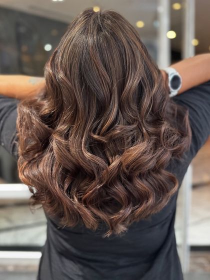 This shot captures the beautiful blend of the mocha balayage from the back, highlighting the seamless transition of colors.