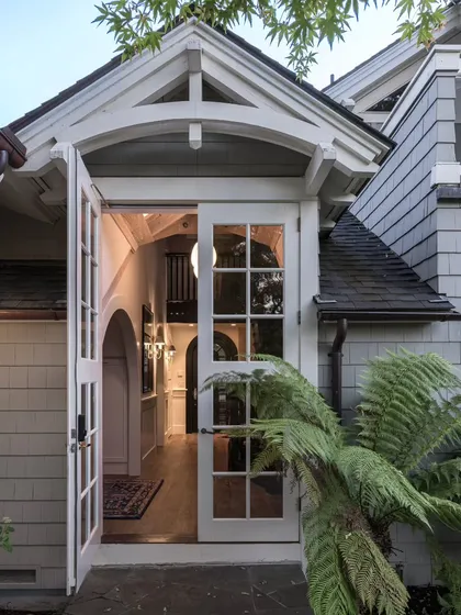 The entrance to this Saratoga home offers a glimpse of the warmth within. We wanted the first impression to be one of welcome and character. The classic American architecture with its gabled roof and French doors opens into a home filled with Indian heritage and modern design, a theme that begins right at the doorstep.