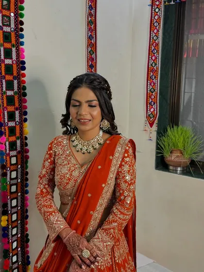 This side profile showcases the elegant braided hairstyle and how it seamlessly integrates with her overall look for the engagement ceremony.