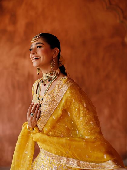 A candid, happy moment. Her smile says it all. The makeup looks fresh and natural, capturing her joyful spirit.