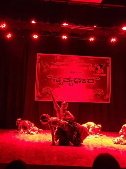 A performance shot under the red lights at the Nrithyadhare festival.