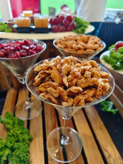 Healthy and elegant snack options like walnuts, almonds, and cranberries, beautifully presented in martini glasses for the Bombay Gymkhana celebration.