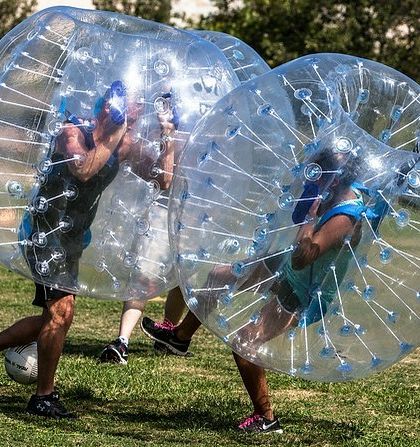 Body Zorbs are wearable inflatable bubbles that allow players to safely bump and roll into each other. They are perfect for organizing fun games like bubble soccer on a grassy field.