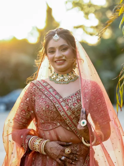 This photo, taken during the golden hour, shows how the makeup beautifully catches the sunlight. The highlighter on the cheekbones gives a stunning, ethereal glow.