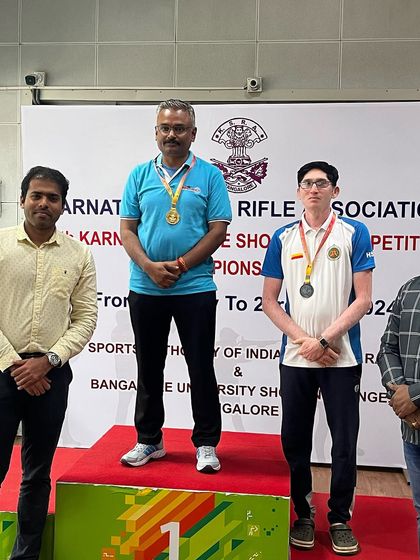 Krishna Prasad stands proudly on the top of the podium after winning the Gold medal in the Pistol Master men's event.