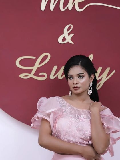 A lovely portrait showcasing the soft makeup and elegant hairstyle.