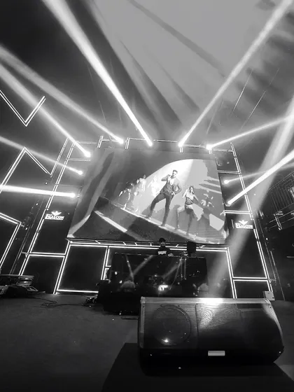 A black and white shot that captures the drama of my AV setup. The powerful stage lights and the visuals on the screen work together to create a stunning, concert-like atmosphere, even at corporate events.