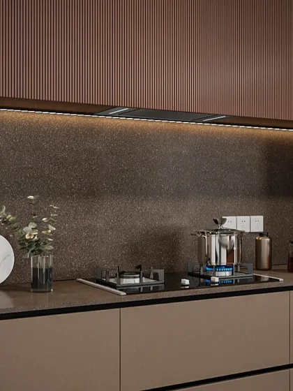 Detail of the fluted texture on the upper cabinets paired with a durable, stone-finish backsplash. These material choices add depth and character to the minimalist design.