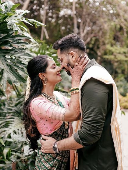 A romantic portrait of Ankita and Karan. Her beautiful green and pink saree and custom blouse create a memorable look for their pre-wedding photos.