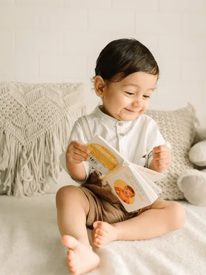 A happy smile while flipping through his little book.
