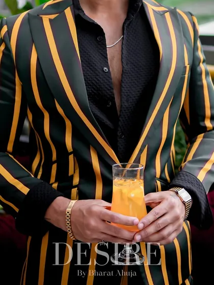 A detail shot of the green and yellow striped blazer. The bold pattern and rich colors are designed for the man who loves to stand out.