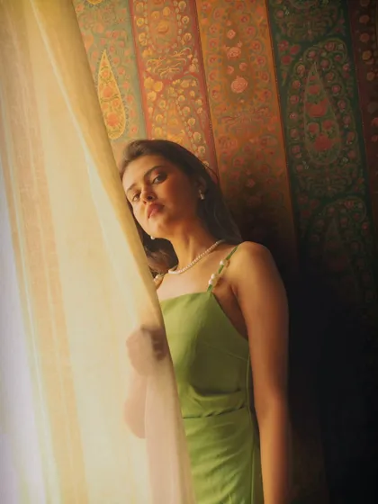 A pensive, thoughtful moment by the window. I love how the light and shadow play across her face, adding depth and mood to the shot.