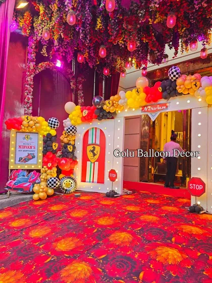 The entrance to a high-energy Ferrari themed birthday party, designed to look like a pit stop with branded doorways and checkered flag details.