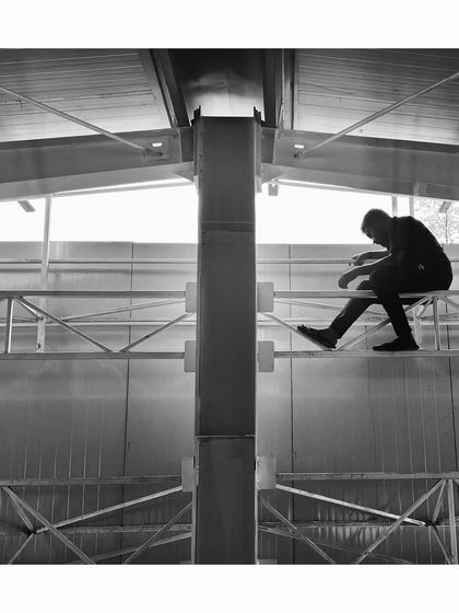 A worker sits atop the steel structure during a site visit. These candid moments capture the human effort and scale involved in realizing our architectural visions.