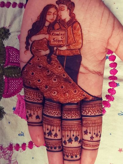 A single-hand maternity design showing an expecting couple holding a "Coming Soon" sign. The fingers are decorated with stars, perfect for a simple yet meaningful look.