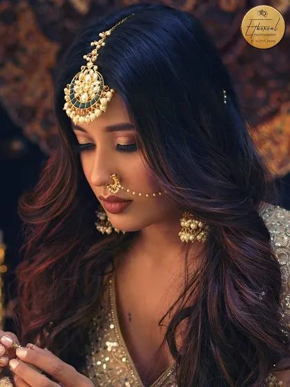 A close-up portrait focusing on the intricate details of the maang tikka, nath, and earrings. This type of shot is essential for jewellery brands and makeup artists to showcase their work.