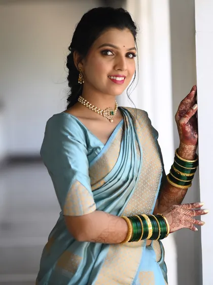For her first engagement look, this bride chose a serene light blue saree. The makeup is soft and fresh, perfect for a daytime ceremony.