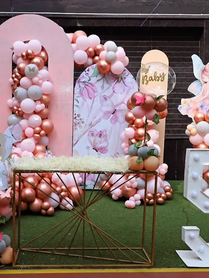 The main backdrop for a fairy party, featuring beautiful floral prints, a light-up number '5', and a delicate fairy cutout.
