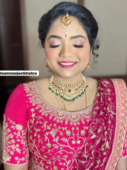 A happy smile from the bride's sister. The pink tones in her makeup not only match her lehenga but also give her a fresh, youthful glow perfect for a daytime wedding event.
