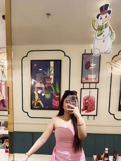 A mirror selfie showing off the fit of this pink party dress. It’s designed to be both comfortable and incredibly chic.