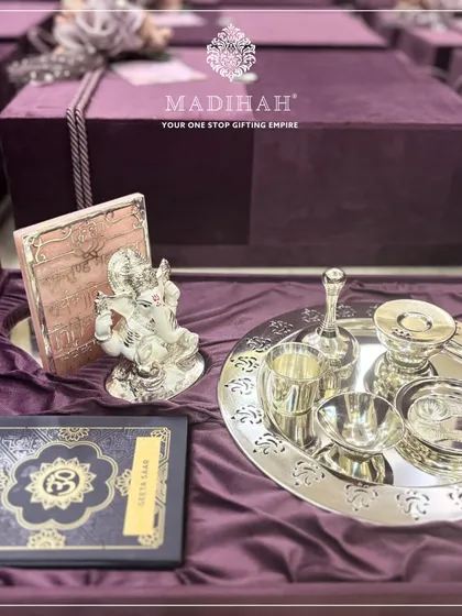 The complete Pooja Auspicious Hamper, featuring the silver-plated thali set, a silver Ganesha idol, and a copy of the Geeta Saar, all presented in a deep purple velvet box. It is a perfect gift for housewarmings or weddings.