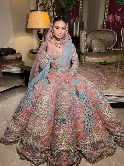 The final regal look, with a sleek updo complementing her magnificent lehenga.