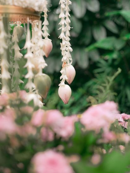 A close-up of the delicate floral details. These hanging lotus buds and jasmine strings, part of the engagement decor, showcase my commitment to adding beautiful, handcrafted touches to every event.