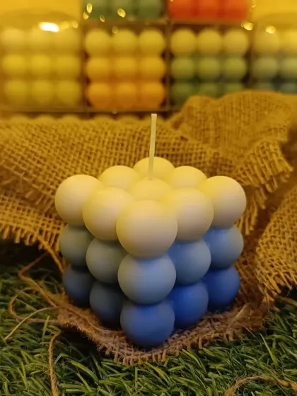 This is my triple-color ombre bubble candle, a modern sculptural piece that adds a pop of color to any room. Each one is hand-poured to create this unique gradient effect.
