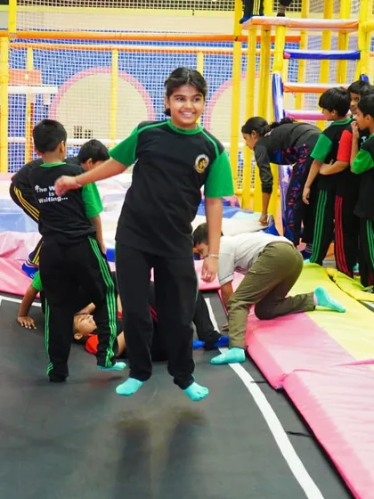Pure joy on the faces of students as they bounce together during their school trip.
