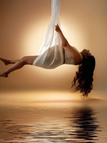 Suspended in serenity, wrapped in elegance. This shot speaks of strength, grace, and the ethereal journey of motherhood.