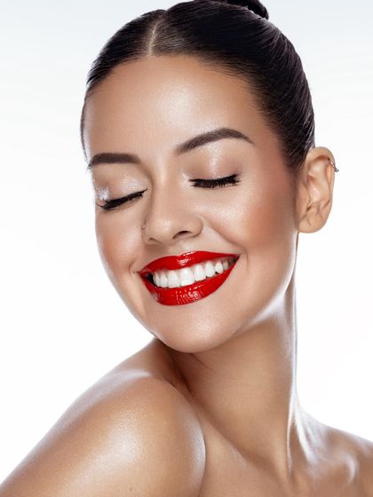 Glossed lips and joyous grins. A classic high-key beauty shot with a bold red lip, a style that is always a great addition to any makeup artist's portfolio.