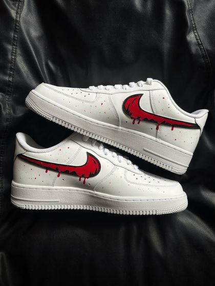 A top-down view of the red drip custom sneakers.