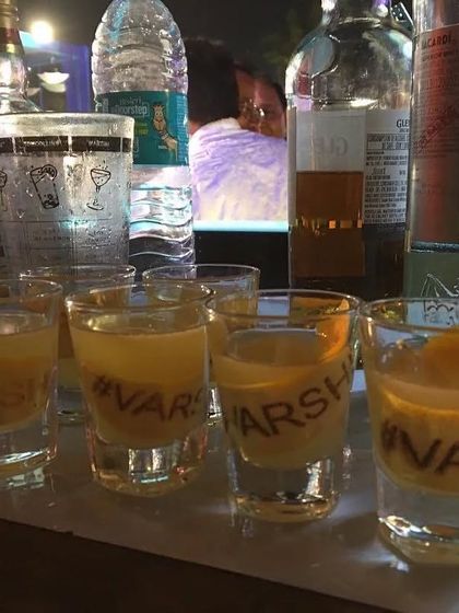 Custom shots with the wedding hashtag '#VARSHI' printed on them, a fun and personalized way to get the party started.