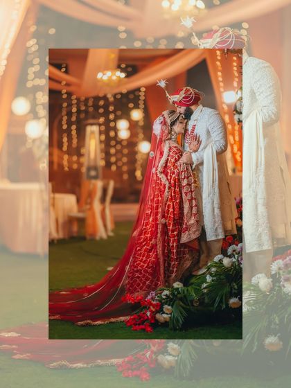 An artistic, softly focused shot of the couple sharing an intimate moment, framed by the warm glow of the wedding decor.
