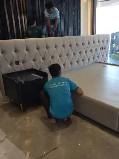 My team is on-site, assembling a custom-upholstered bed with a large, tufted headboard. I handle the entire process, from building the frame in my workshop to ensuring a clean and professional installation in your home.