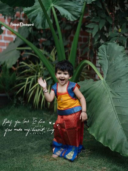 Cuteness level: off the charts. Her happy wave and traditional dress are a perfect combination.
