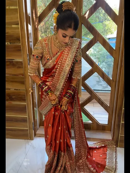A full-length shot of the bride, showing the beautiful drape of her saree.