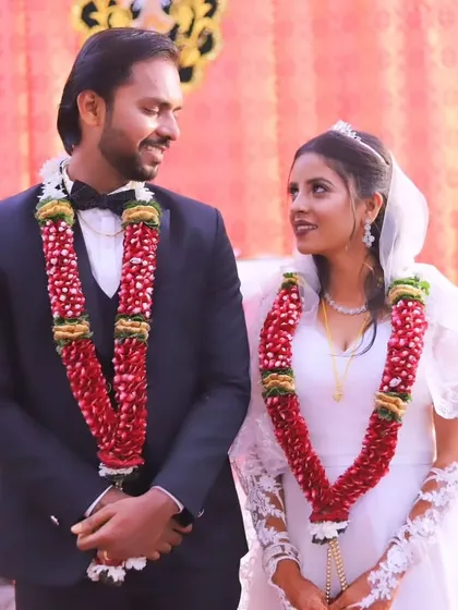 The happy couple. The bride's makeup is soft and romantic, perfect for her white wedding gown and veil.