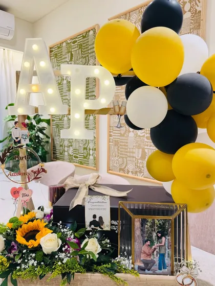 A stunning black and gold themed wedding hamper, complete with light-up initials, sunflowers, and a premium silver keepsake set for the newlyweds.