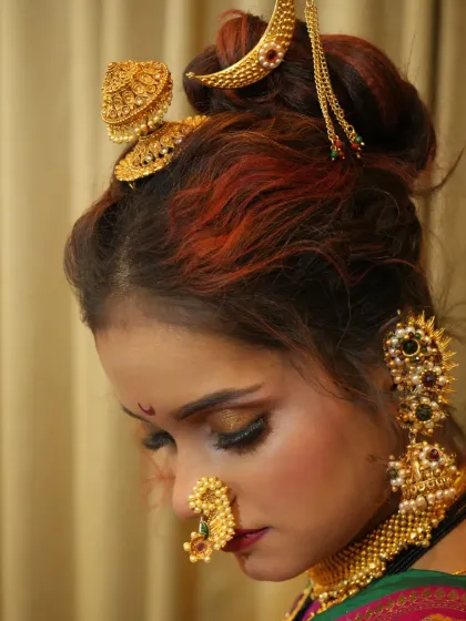 The elegance of a Peshwai bride is in her poise. This side profile highlights the intricate hairstyle, adorned with traditional hair accessories, a skill we cover in our hairstyling modules.