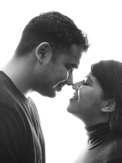 The sweet "almost kiss" moment. This black and white portrait is so full of tenderness and joy, capturing the couple's affection in a classic, timeless way.