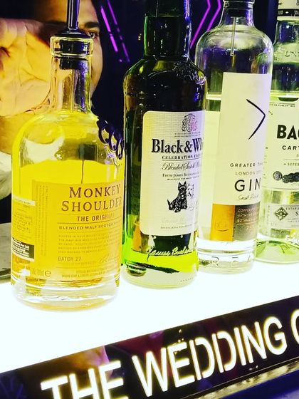 A close-up of the premium brands we stock, including Monkey Shoulder and Black & White, ensuring quality drinks for your guests.