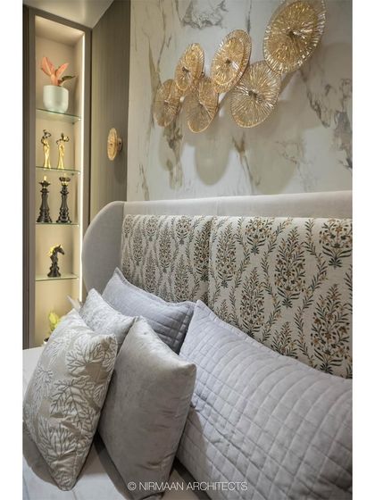 A close-up of the patterned headboard and layered pillows in the Duplex Project's master bedroom. The mix of textures and patterns adds depth and visual interest to the design.