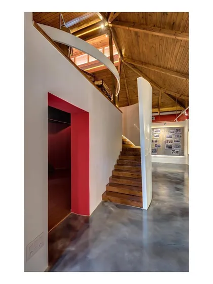 A detail of the new staircase and mezzanine level inside the museum. This intervention allows for vertical circulation and creates additional display area, maximizing the utility of the original building's volume without compromising its character.