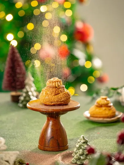 An action shot of powdered sugar being dusted over a Christmas pastry. Capturing motion like this adds a dynamic and delicious element to your food videos.