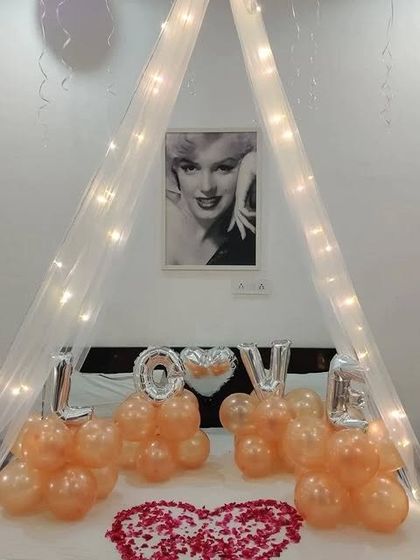 A detailed shot of the bed canopy and "LOVE" balloon arrangement.