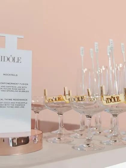 The bar setup for the Lancôme Idôle event, featuring custom-shaped menus and branded drink stirrers. Every element of the bar was designed to synergize with the product launch.