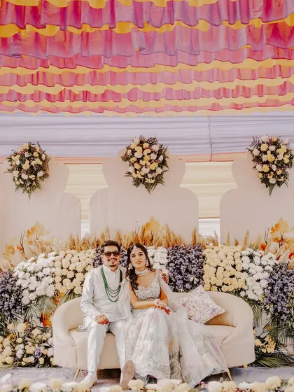 A moment of calm amidst the carnival. I captured this portrait of Rahul and Riya on their beautifully decorated Haldi stage, showcasing their stylish outfits and the stunning floral decor.