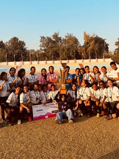 The spoils of victory. The entire team posing with the championship trophy and the winner's cheque.
