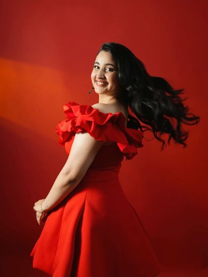 A fun, twirling shot of Revathi Pillai in her red dress for the Kota Factory screening, capturing her vibrant personality.